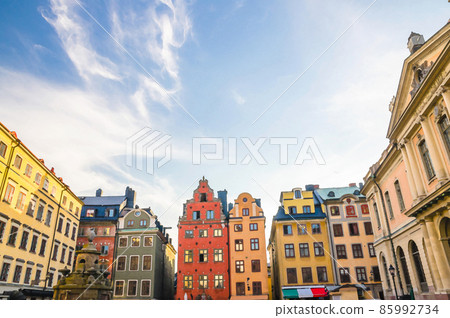 Watercolor drawing of Traditional buildings with colorful walls, Nobel Museum and fountain on Stortorget square in old historical town quarter Gamla Stan 85992734
