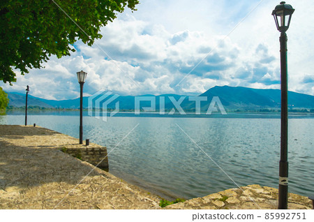 Watercolor drawing of Lampposts on the embankment promenade of Lake Orestiada 85992751