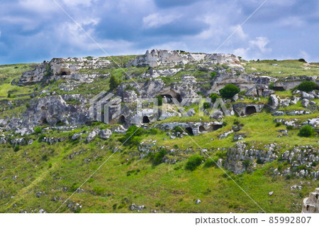 Watercolor drawing of View of ravine canyon with rocks and houses in caves di Murgia Timone near old ancient town Matera 85992807