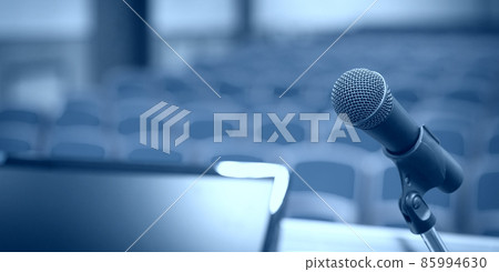 Rostrum with microphone and computer in conference room 85994630