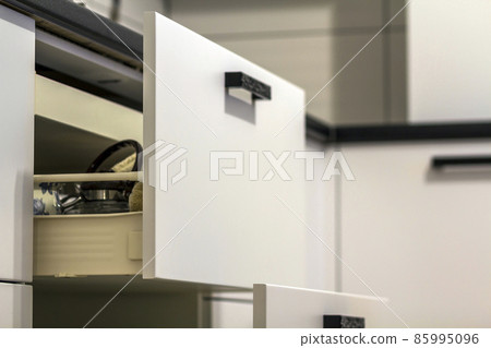 Open kitchen drawers with plates and cups dishes Open kitchen drawers with plates and cups dishes 85995096