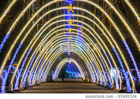 Night view of New Year or Christmas decorative arches with bright lights during winter holidays in Ivano-Frankivsk city, Ukraine. 85995104