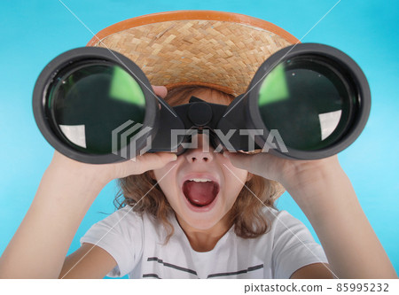 Beautiful young girl  looking through binoculars with surprised expression 85995232