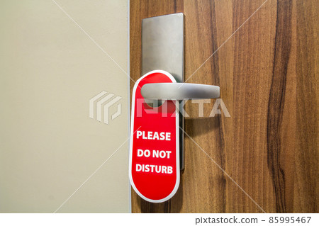 Door of hotel room with sign please do not disturb. Door of hotel room with sign please do not disturb. 85995467