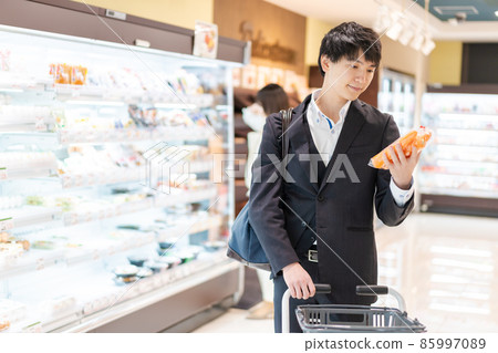 A businessman buying vegetables at a supermarket A businessman buying vegetables at a supermarket 85997089