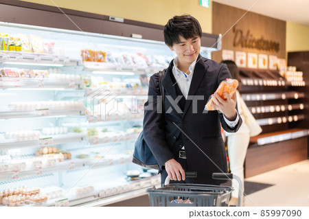 A businessman buying vegetables at a supermarket A businessman buying vegetables at a supermarket 85997090
