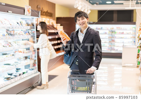 A businessman buying vegetables at a supermarket A businessman buying vegetables at a supermarket 85997103