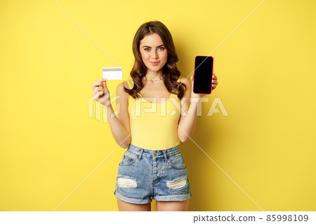 Young beautiful woman model showing smartphone - Stock Photo [85998109]  - PIXTA