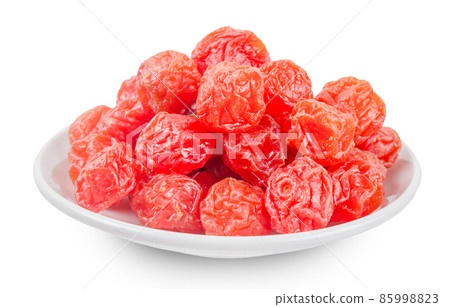 Dried red prunes fruits (Preserved fruits Chinese plum) in withe dishl isolated on white background. 85998823