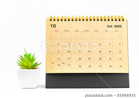 October 2022 Desk calendar with plant pot on white table. October 2022 Desk calendar with plant pot on white table. 85998935