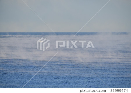 Taking a picture of the scenery of the Sea of Japan rising up on the Fushikido coast in Esashi-cho, Hokkaido in winter Taking a picture of the scenery of the Sea of Japan rising up on the Fushikido coast in Esashi-cho, Hokkaido in winter 85999474