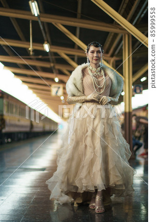 Retro vintage portrait of beautiful Gatsby woman stand look around, wait coming train for lover Retro vintage portrait of beautiful Gatsby woman stand look around, wait coming train for lover 85999558