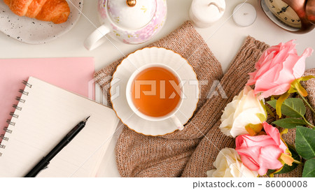 Feminine workspace concept, A notebook with a set of English afternoon tea 86000008