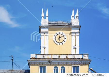 Novokuznetsk city, Russia, 22.07.2021: old building in the Kuznetsky district of the city with clock Novokuznetsk city, Russia, 22.07.2021: old building in the Kuznetsky district of the city with clock 86000629