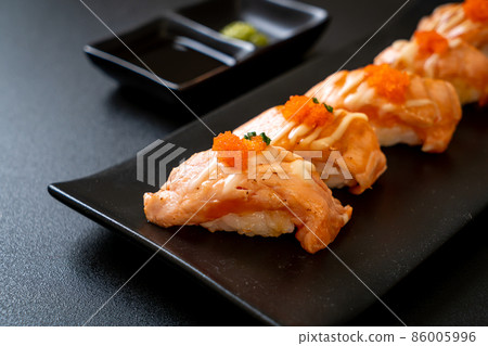 grilled salmon sushi on black plate 86005996