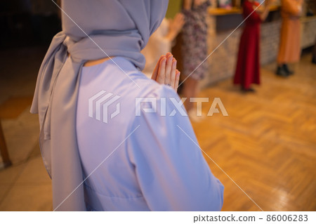 Woman putting hands up and dancing. Excited young female celebrating a victory. Muslim woman in traditional Islamic clothing - hijab. Birthday, New Year celebration concept. Woman putting hands up and dancing. Excited young female celebrating a victory. Muslim woman in traditional Islamic clothing - hijab. Birthday, New Year celebration concept. 86006283