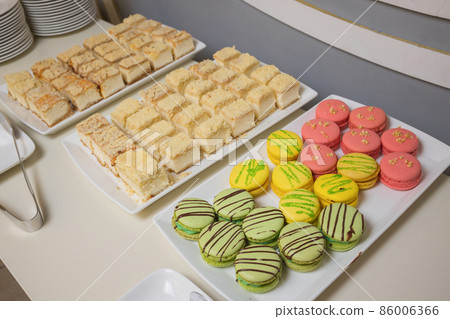 Candy bar on wedding party with a lot of different candies, cupcakes, souffle and cakes. Candy bar on wedding party with a lot of different candies, cupcakes, souffle and cakes. 86006366