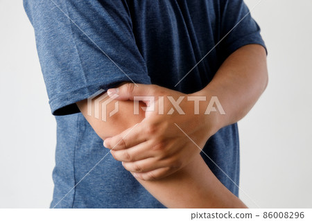close up man guy holding touching painful elbow Pain relief concept close up man guy holding touching painful elbow Pain relief concept 86008296