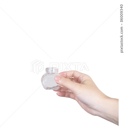 Hand holding a glass bottle Hand holding a glass bottle 86009340