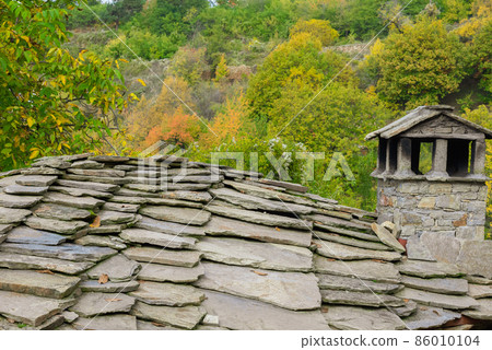 Old traditional Bulgarian house in mountain village of Kovachevitsa. Traditional slan stone roofs 86010104