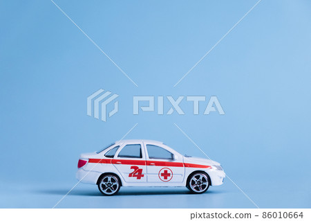Ambulance Car on blue background. An emergency medical service. Toy Medical vehicle model. Ambulance Car on blue background. An emergency medical service. Toy Medical vehicle model. 86010664