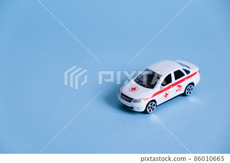 Ambulance Car on blue background. An emergency medical service. Toy Medical vehicle model. Ambulance Car on blue background. An emergency medical service. Toy Medical vehicle model. 86010665