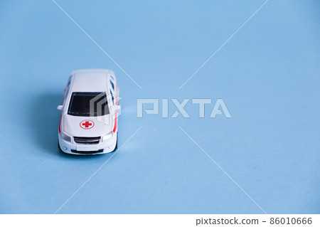 Ambulance Car on blue background. An emergency medical service. Toy Medical vehicle model. 86010666