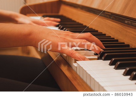 pianist playing the piano, close up view of hands and keys pianist playing the piano, close up view of hands and keys 86010943