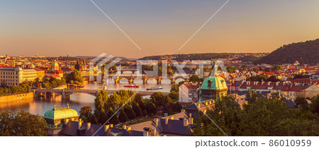 Prague, Czech republic - 08 14 2021: the old city with the Vltava river, at sunset Prague, Czech republic - 08 14 2021: the old city with the Vltava river, at sunset 86010959
