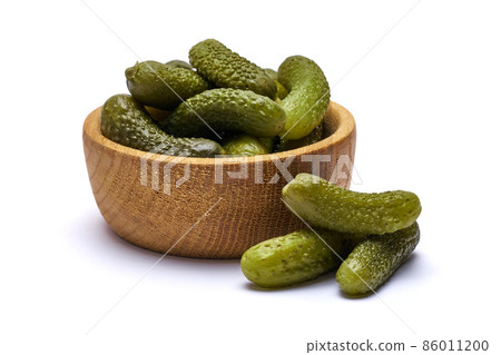 Bowl of Tasty canned Whole green cornichons isolated on a white background Bowl of Tasty canned Whole green cornichons isolated on a white background 86011200