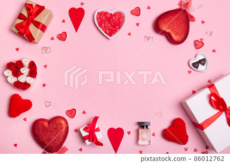 Valentine's Day. Frame made of hearts, gifts, candles, confetti on pink background. Valentines day background. Valentine's Day. Frame made of hearts, gifts, candles, confetti on pink background. Valentines day background. 86012762