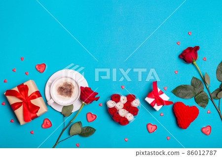 Valentine's Day background. Gift, coffee roses, candles, hearts on blue background. Valentines day concept. 86012787