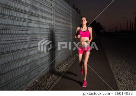 Running woman. Runner jogging in evening. 86014083