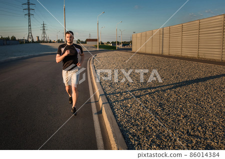 Full length portrait of athletic man running 86014384