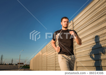 Close-up portrait of athletic man running 86014386