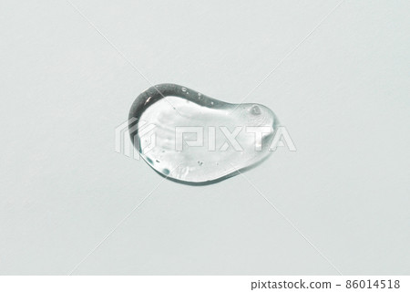 Transparent hyaluronic acid gel drop on a gray background. 86014518