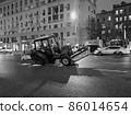 Broken agricultural tractor on night Moscow street, Russia 86014654