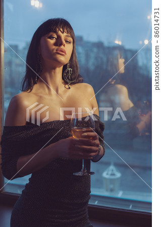 Beautiful woman with a glass of wine. 86014731