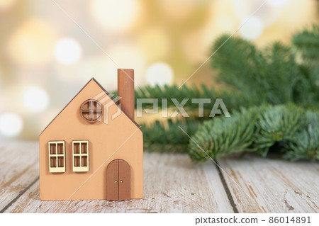 A model of an eco-friendly wooden house on a winter background. A model of an eco-friendly wooden house on a winter background. 86014891