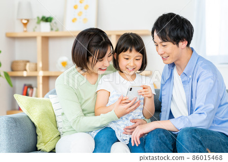 Young family relaxing in the living room Young family relaxing in the living room 86015468