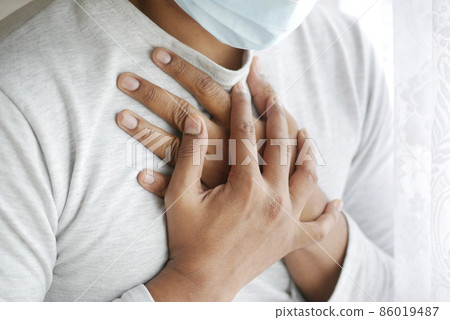 young sick man coughing and sneezes  86019487