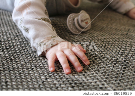 Detail of young baby hand with dummy Detail of young baby hand with dummy 86019839