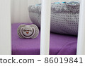 Detail of nice dummy in child cot 86019841