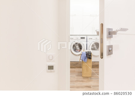 View through door to laundry room with basket and washing machine View through door to laundry room with basket and washing machine 86020530