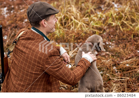 Hunting period, autumn season open. confident caucasian hunter with dog and gun 86023484