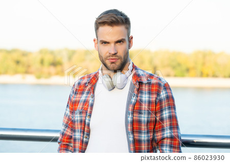 portrait of male fashion model. education online. listening audio book. 86023930