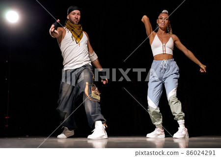 youth learning new hip-hop movements together in studio, wearing stylish clothes youth learning new hip-hop movements together in studio, wearing stylish clothes 86024291