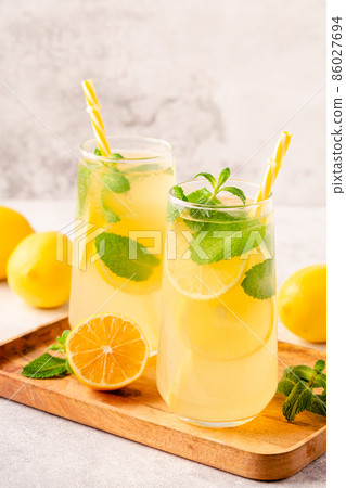 Lemonade with lemon, mint and ice cubes in glass 86027694
