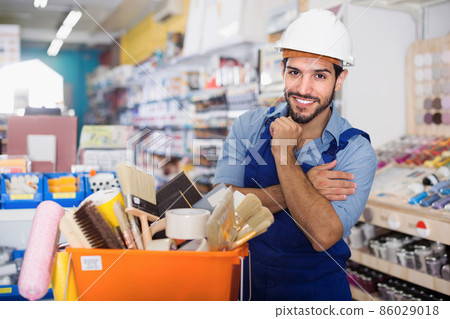 Worker standing crossed hands near basket with tools Worker standing crossed hands near basket with tools 86029018