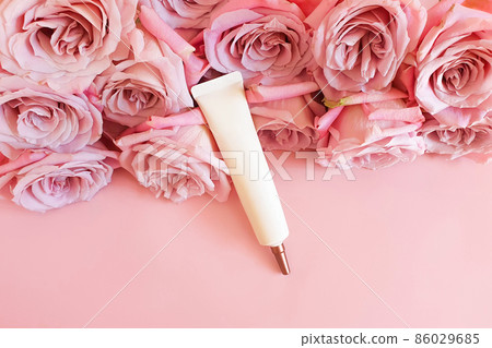 White ivory squeeze cosmetic tube with long nozzle and bronze screw cap and pink roses on pink background. Bottle for branding - cream, gel, skincare, moisturizer, mockup. Top front view, flat lay. White ivory squeeze cosmetic tube with long nozzle and bronze screw cap and pink roses on pink background. Bottle for branding - cream, gel, skincare, moisturizer, mockup. Top front view, flat lay. 86029685
